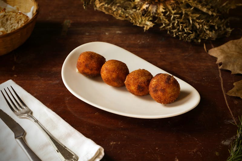 Golden arancini rice balls with ragù filling